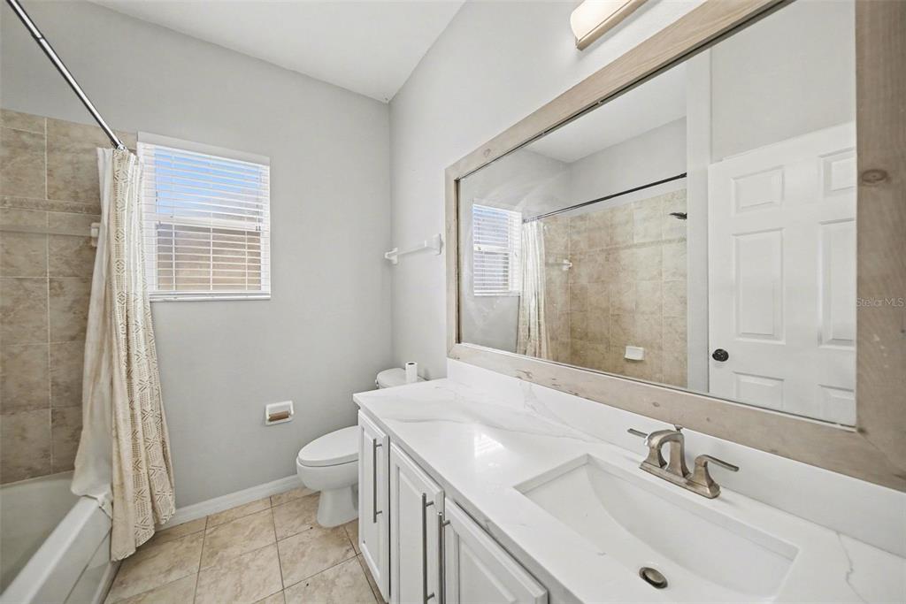 4809 Walnut Ridge Road Land O' Lakes, FL 34638 - Photo 19 of 34 a bathroom with a sink a toilet and shower