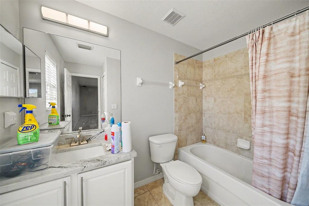 4809 Walnut Ridge Road Land O' Lakes, FL 34638 - Photo 23 of 34 a bathroom with a granite countertop sink a mirror a bathtub and shower