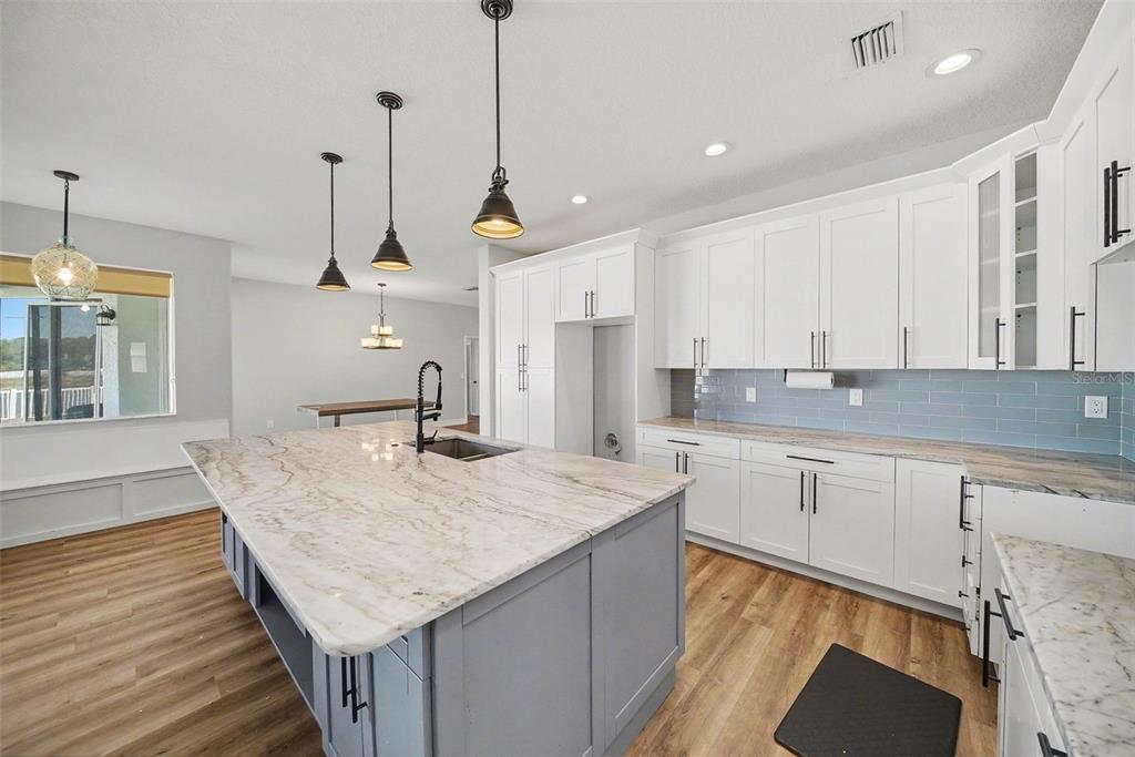 4809 Walnut Ridge Road Land O' Lakes, FL 34638 - Photo 7 of 34 a kitchen with stainless steel appliances granite countertop sink stove and refrigerator