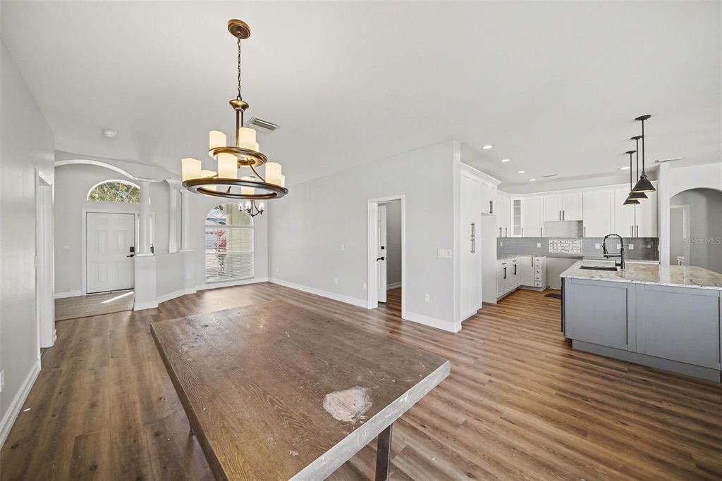 4809 Walnut Ridge Road Land O' Lakes, FL 34638 - Photo 9 of 34 a view of a kitchen with kitchen island a counter space a sink and wooden floor