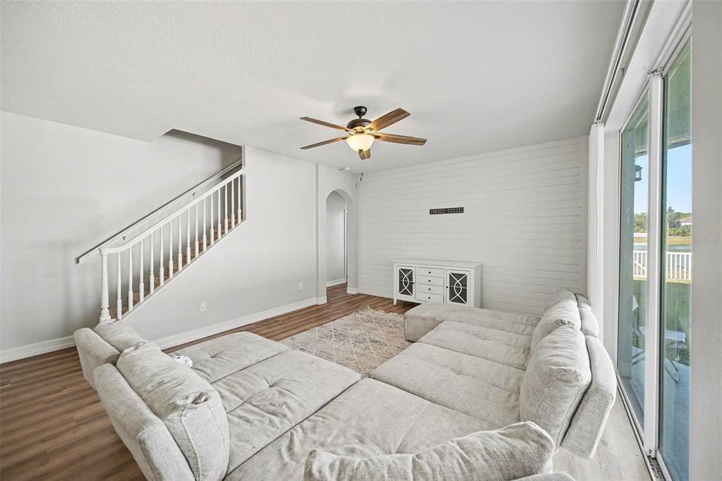 4809 Walnut Ridge Road Land O' Lakes, FL 34638 - Photo 10 of 34 a view of a bedroom with a bed and a chandelier fan