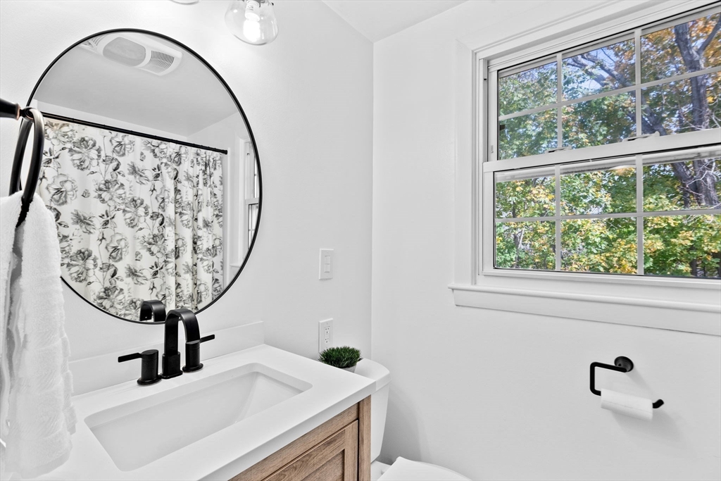 35 Red Jacket Road Weymouth, MA 02190 - Photo 16 of 33 a view of a bathroom with a sink and a mirror