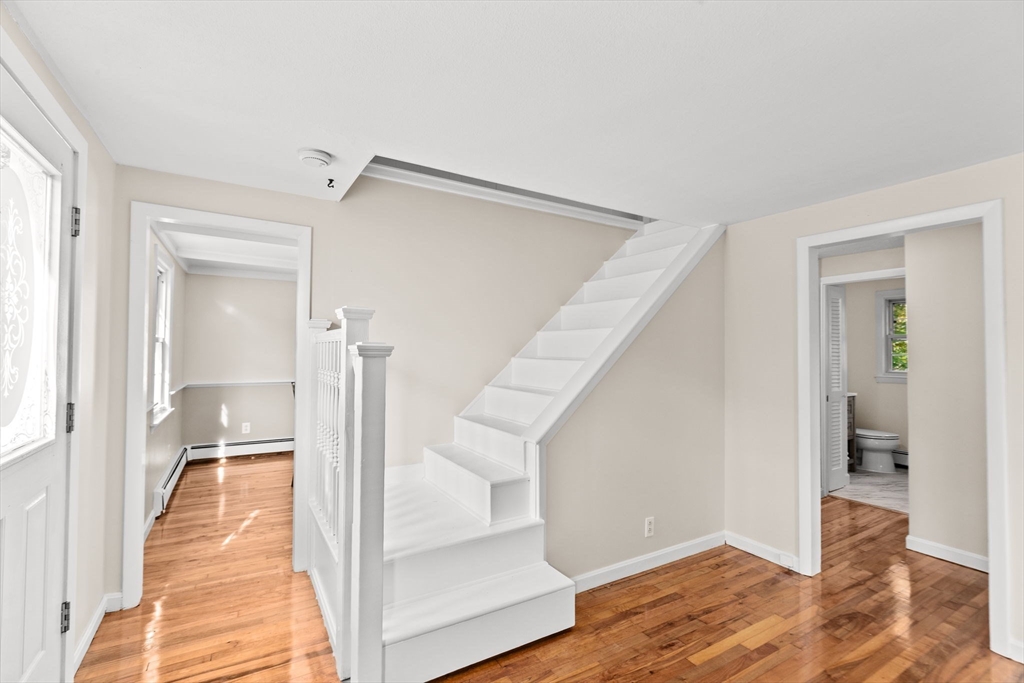 35 Red Jacket Road Weymouth, MA 02190 - Photo 20 of 33 a view of a hallway with white walls and wooden floor