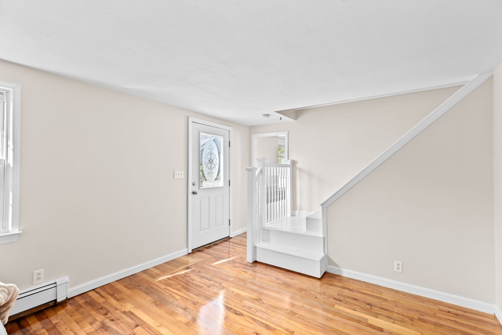 35 Red Jacket Road Weymouth, MA 02190 - Photo 21 of 33 a view of an empty room with wooden floor and stairs