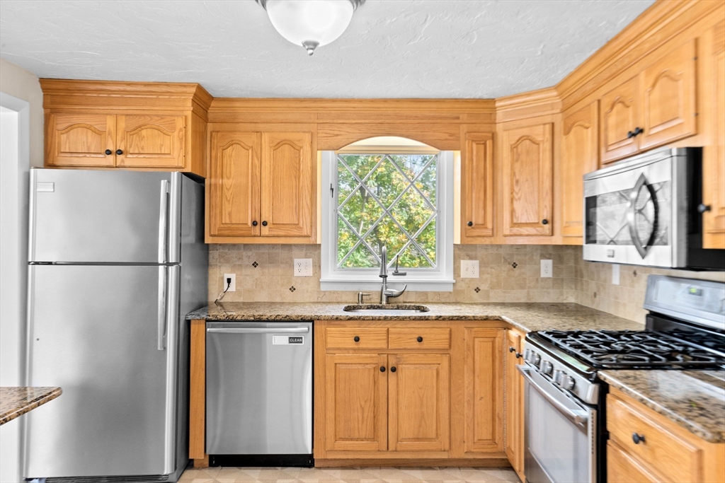 35 Red Jacket Road Weymouth, MA 02190 - Photo 9 of 33 a kitchen with stainless steel appliances granite countertop a refrigerator and a sink