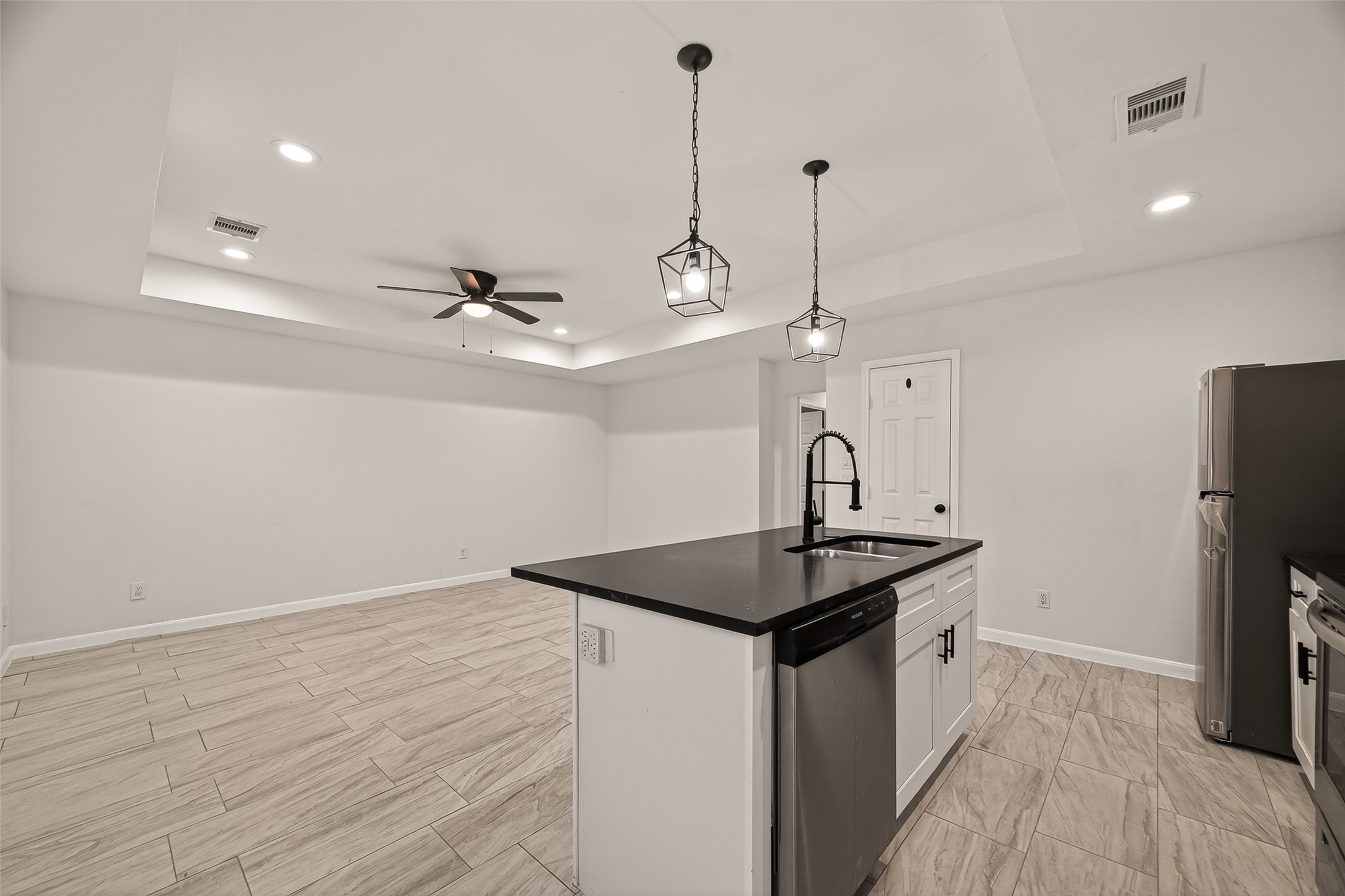 4302 Hirsch Road, Unit B Houston, TX 77026 - Photo 12 of 30 a kitchen with kitchen island a sink appliances and wooden floor