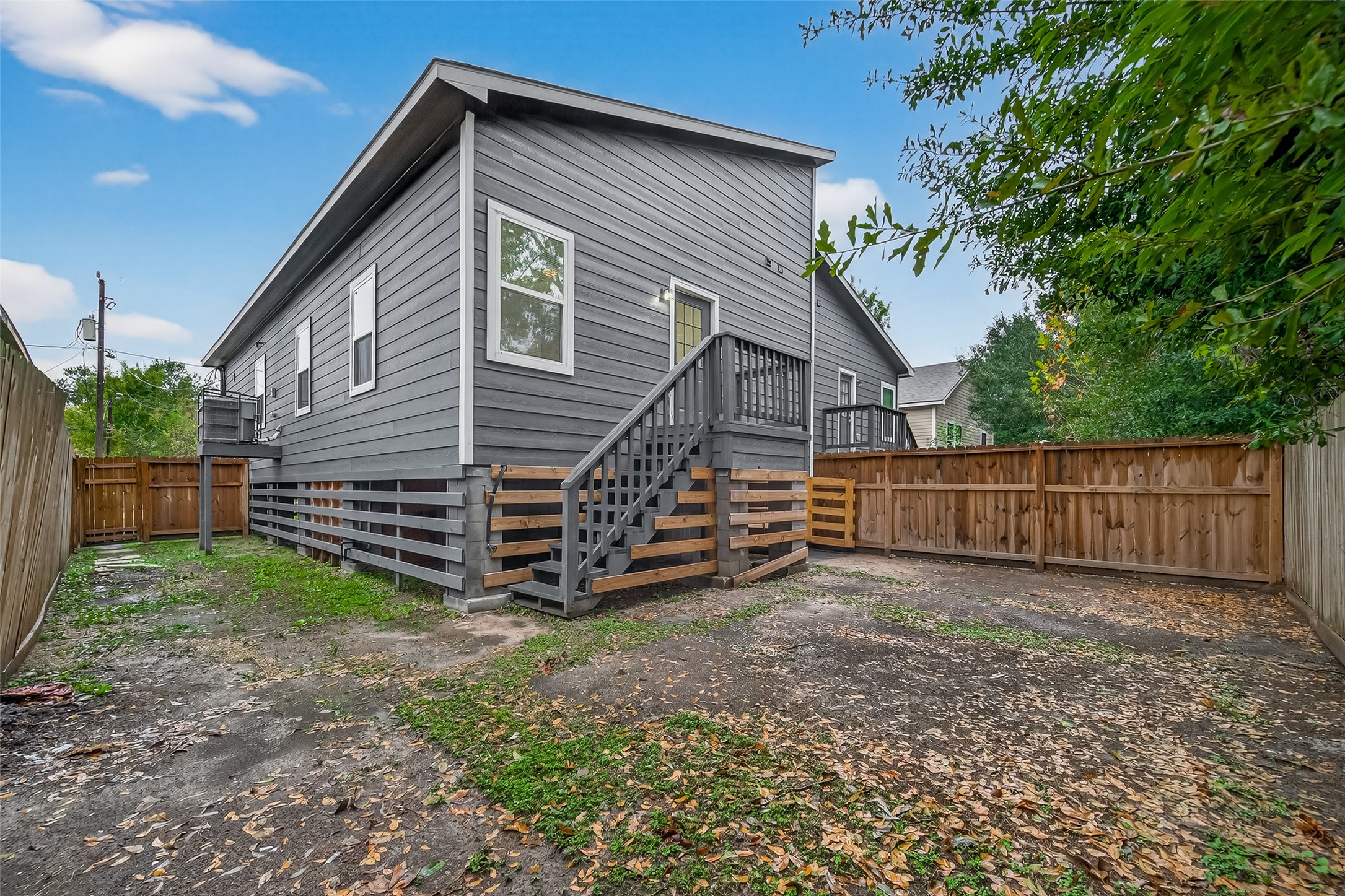 4302 Hirsch Road, Unit B Houston, TX 77026 - Photo 28 of 30 a view of a house with a yard and a wooden fence