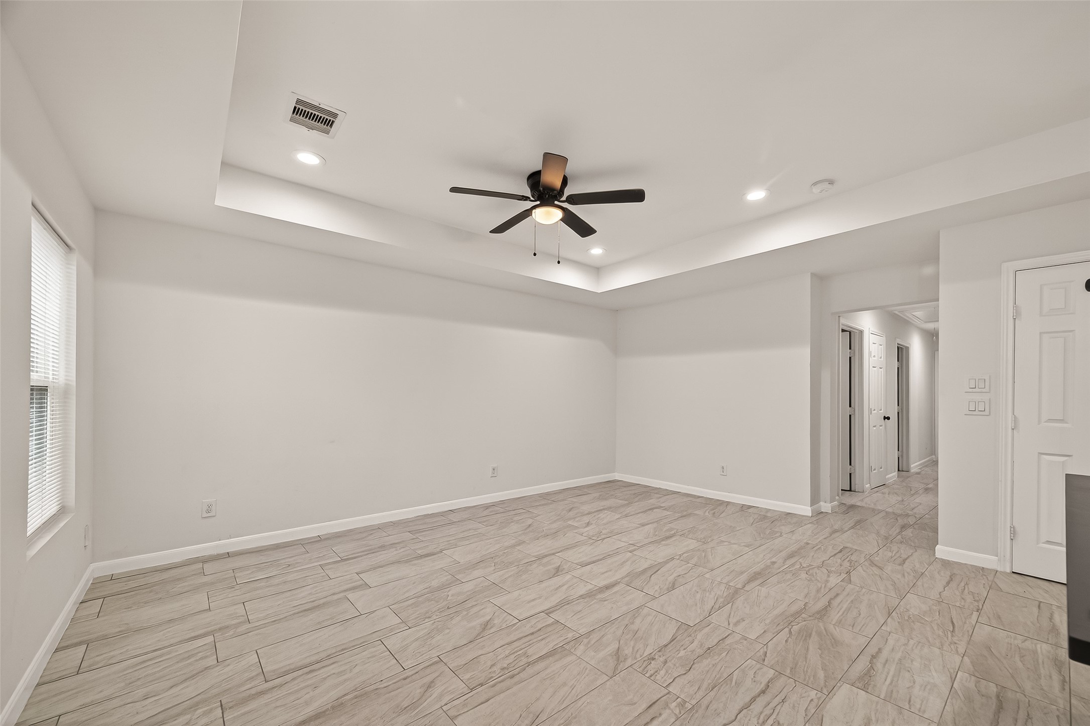 4302 Hirsch Road, Unit B Houston, TX 77026 - Photo 6 of 30 a view of a room with wooden floor and a ceiling fan