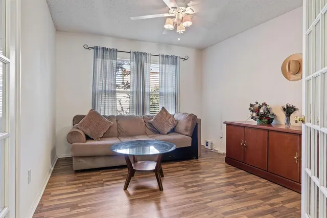 a living room with furniture and wooden floor