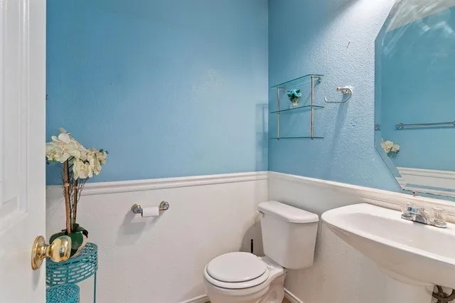 a white toilet sitting next to a bathroom sink