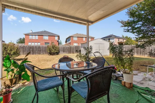 a balcony with table and chairs