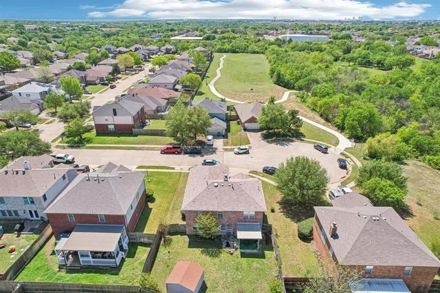an aerial view of residential houses with outdoor space and swimming pool