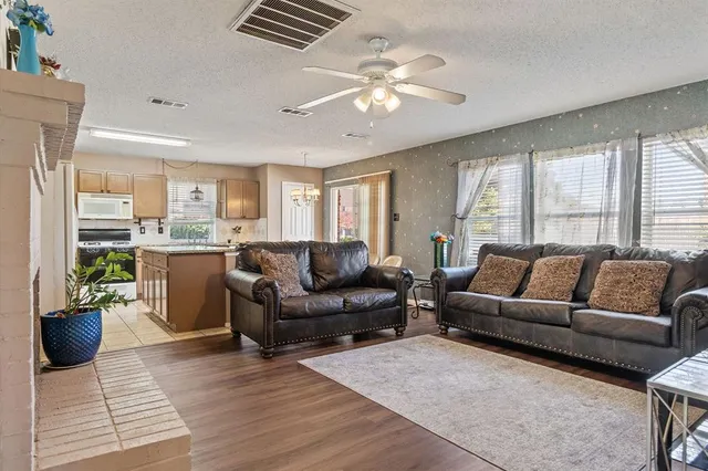 a living room with furniture a chandelier and a dining room