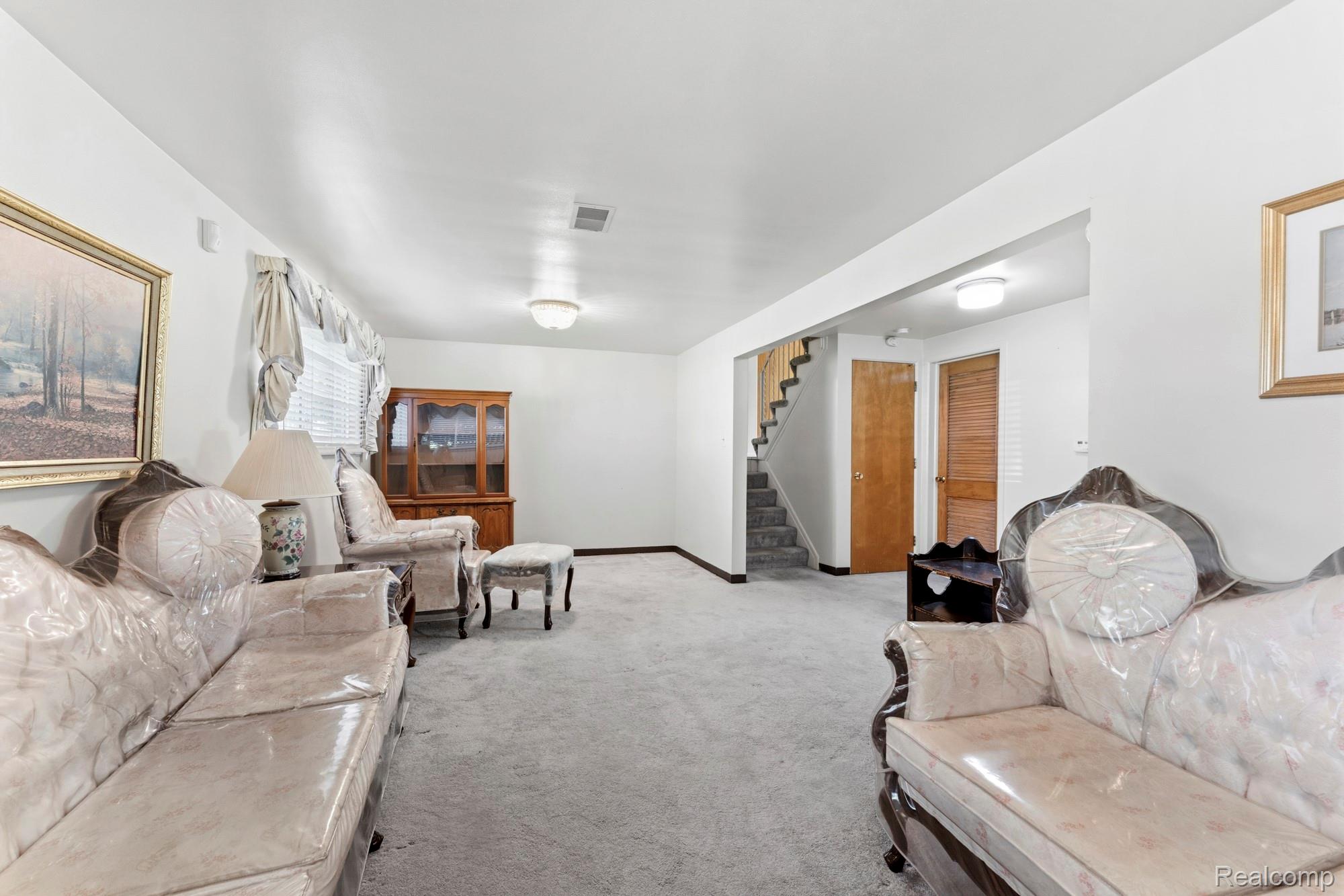 23410 Joy Road Redford, MI 48239 - Photo 11 of 25 Living area with stairway and light carpet