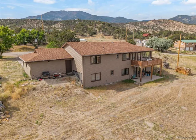 an aerial view of a house with a yard
