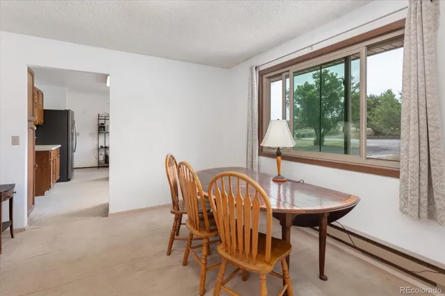 a view of a dining room with furniture window and outside view