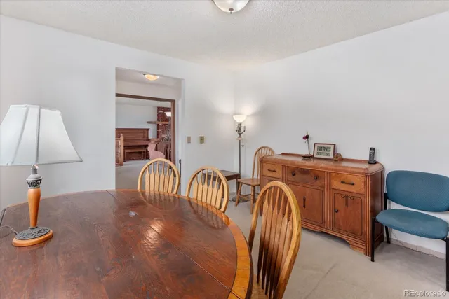 a living room with furniture a lamp and a window