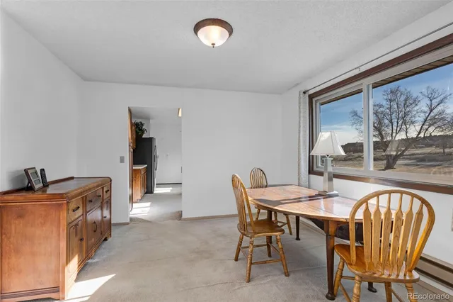 an empty room with a window and ceiling fan