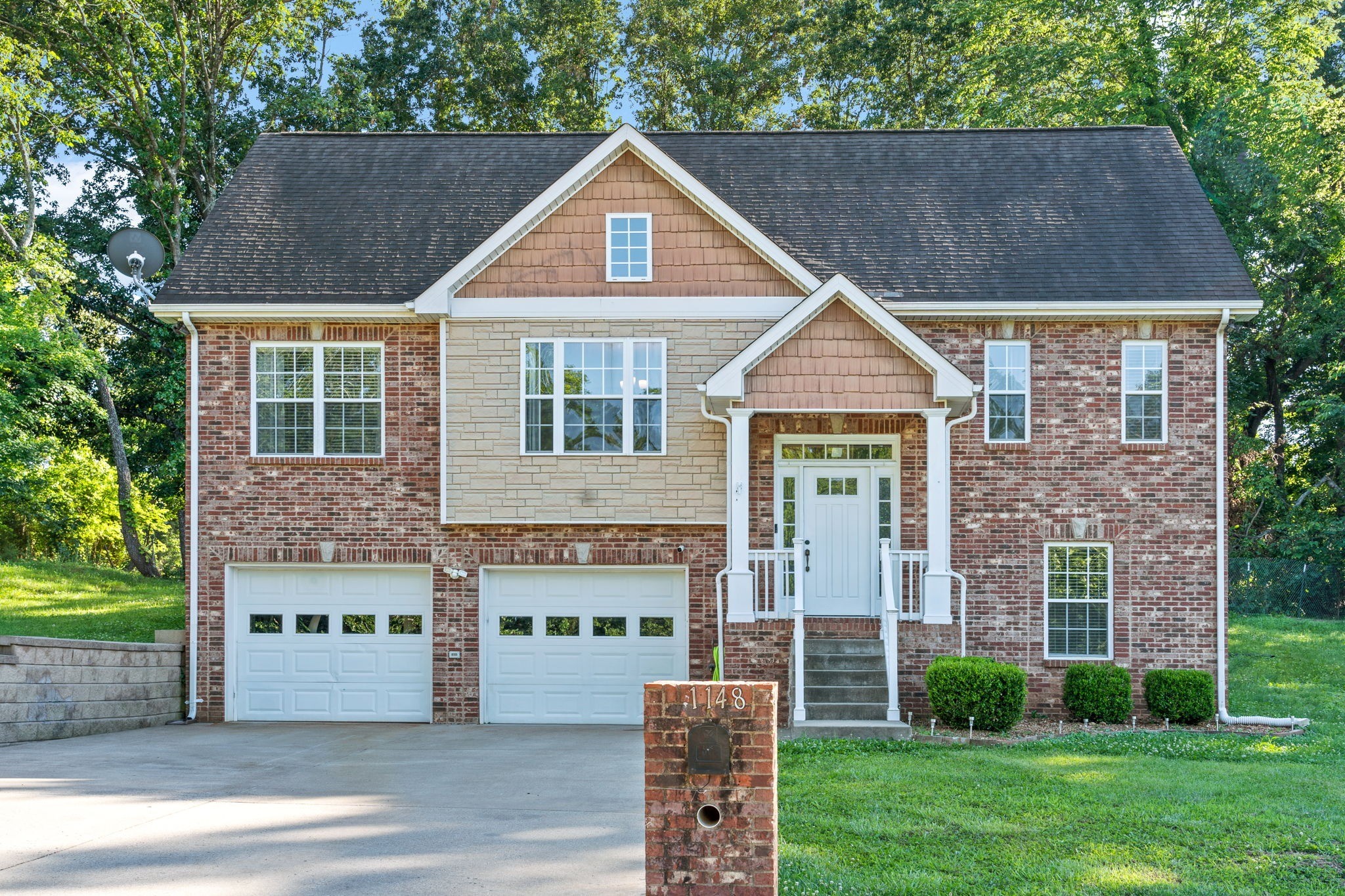 1148 York Meadows Road Clarksville, TN 37042 - Photo 1 of 35 a front view of a house with a garden and plants