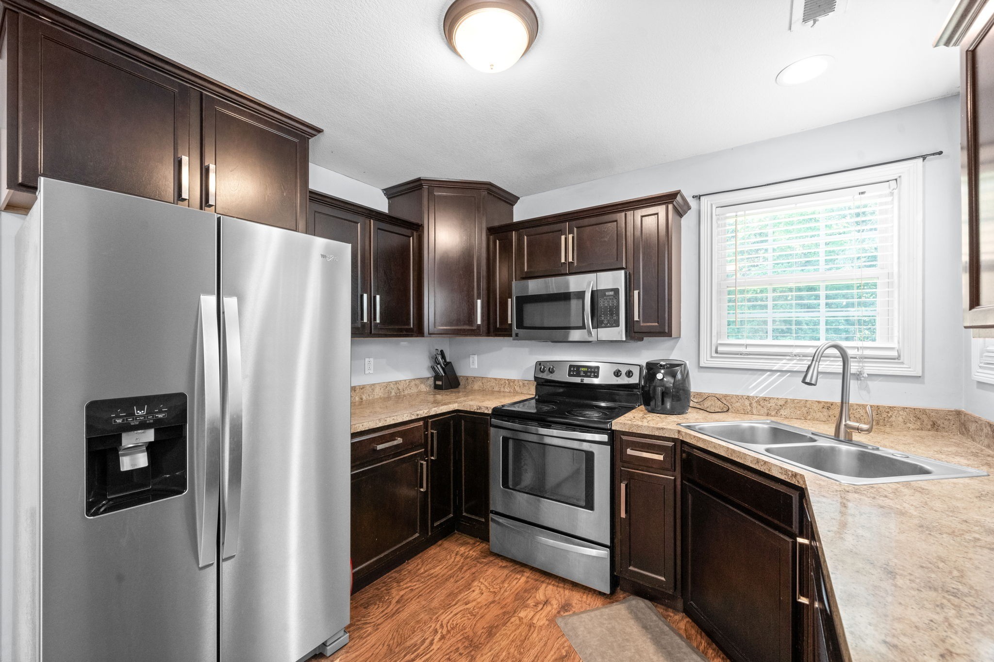 1148 York Meadows Road Clarksville, TN 37042 - Photo 15 of 35 a kitchen with stainless steel appliances granite countertop a sink stove and refrigerator
