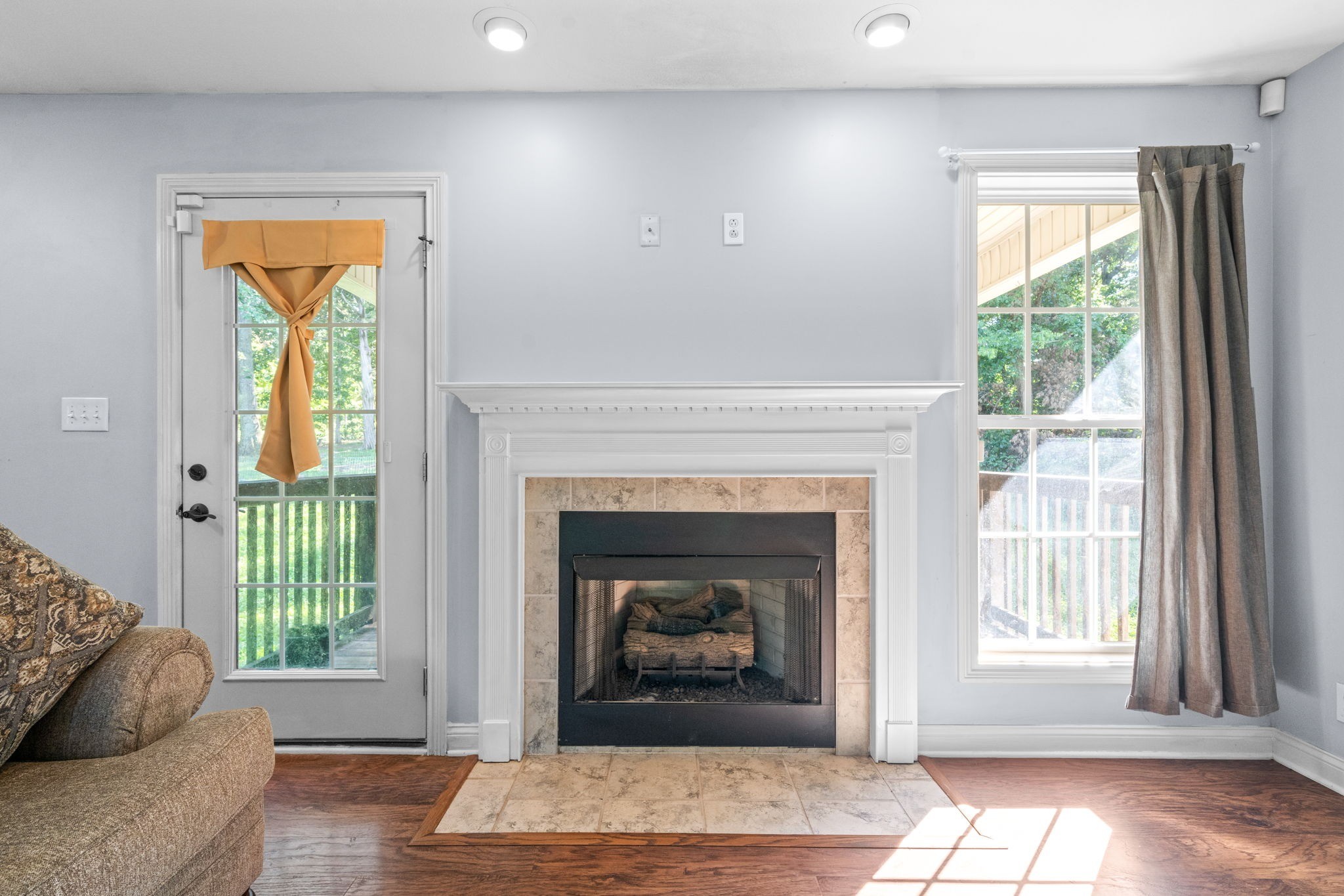 1148 York Meadows Road Clarksville, TN 37042 - Photo 6 of 35 a living room with a fireplace and a floor to ceiling window