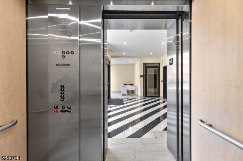 172 6th Street, Unit 54 Passaic, NJ 07055 - Photo 12 of 13 a view of a hallway with wooden floor and staircase