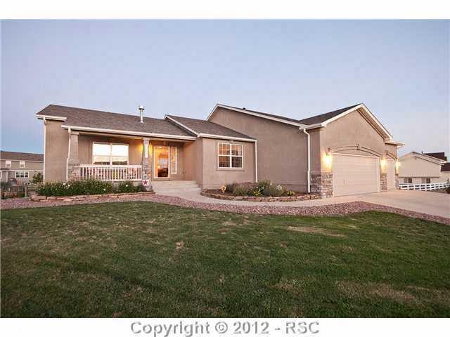 8739 Del Rio Road Peyton, CO 80831 - Photo 2 of 25 Impeccably maintained home w/covered front porch & nicely landscaped lot