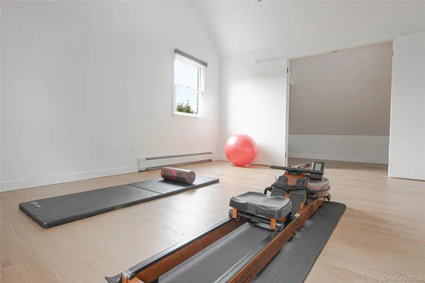 a view of a room with wooden floor and a window