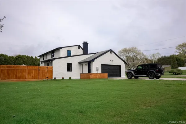 a view of a house with a yard and sitting area