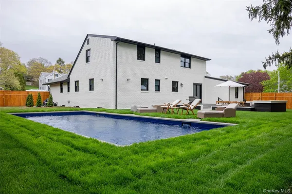 a front view of house with yard and outdoor seating