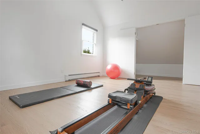 a view of a room with wooden floor and a window