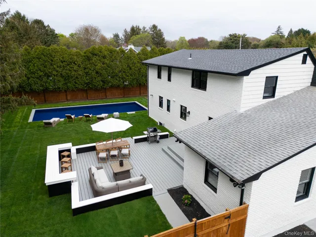 an aerial view of a house with swimming pool garden and mountain view