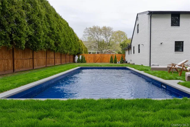 a front view of house with yard and outdoor seating