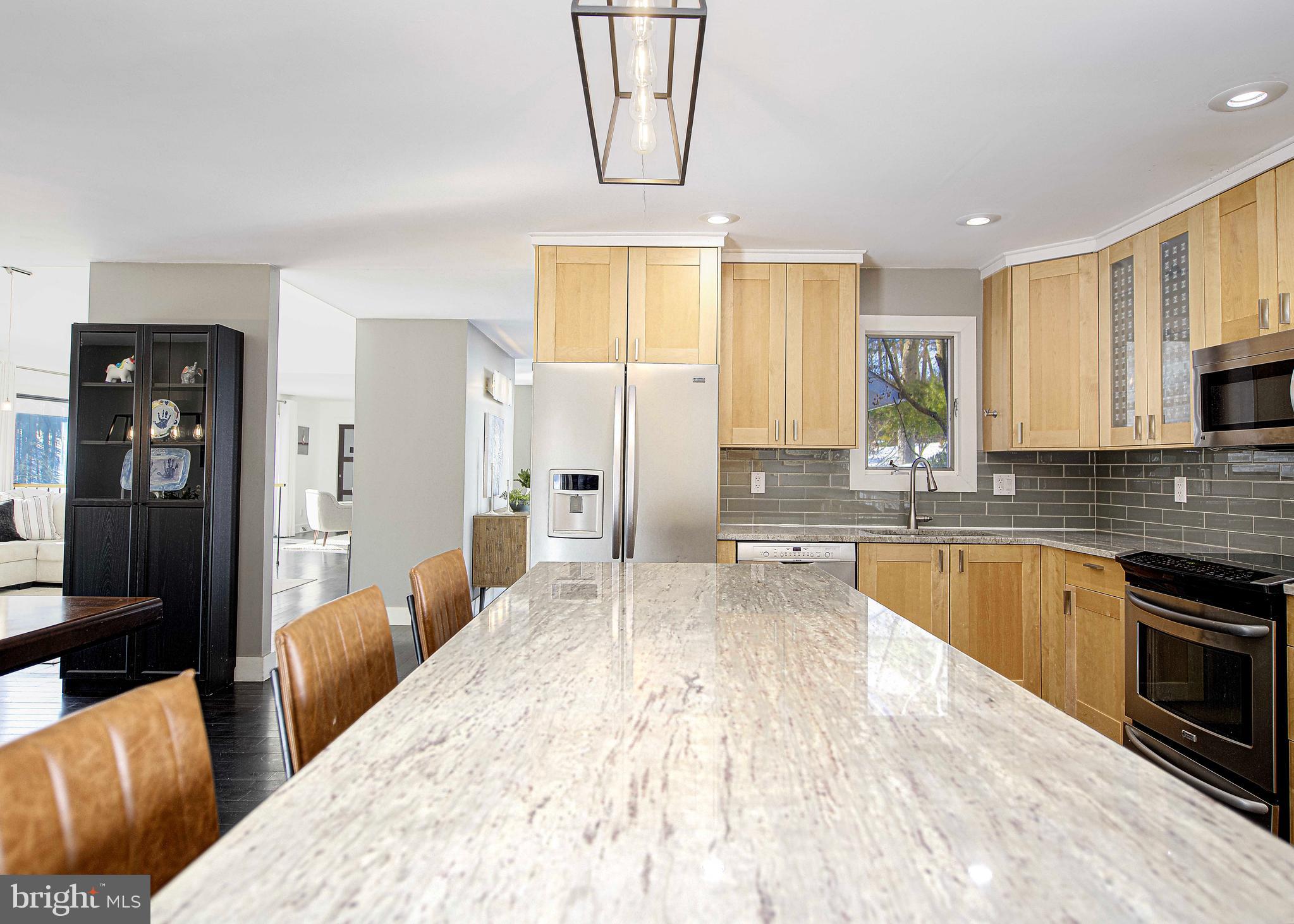 129 Duncannon Road Bel Air, MD 21014 - Photo 5 of 50 a large white kitchen with stainless steel appliances kitchen island granite countertop a refrigerator a stove top oven a sink and dishwasher
