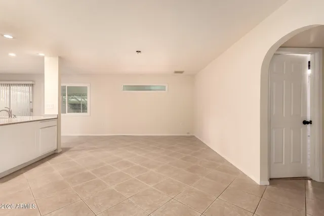 an empty room with windows and entrance