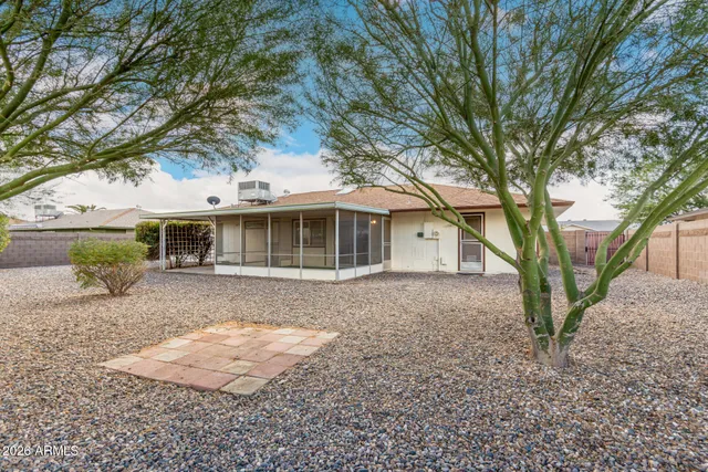 front view of a house with a yard and potted plants