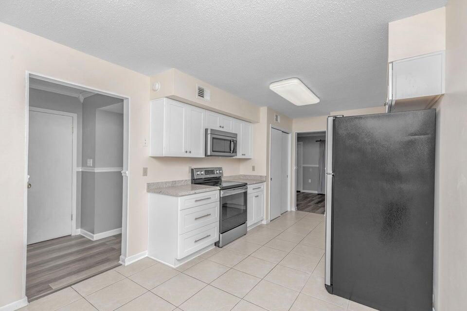 1037 4th Avenue Shalimar, FL 32579 - Photo 11 of 22 a kitchen with stainless steel appliances a refrigerator stove and sink