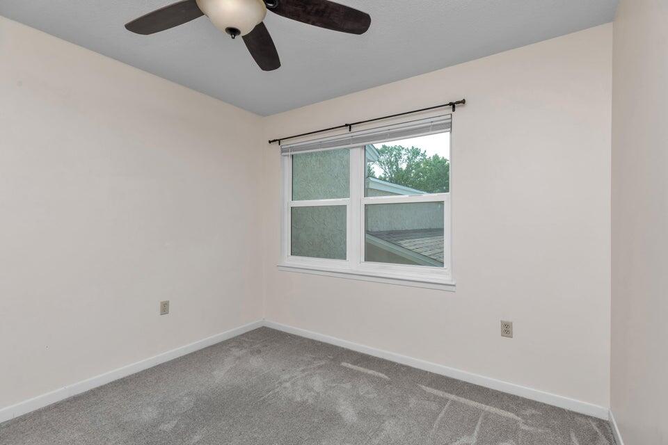 1037 4th Avenue Shalimar, FL 32579 - Photo 13 of 22 an empty room with a window and a ceiling fan