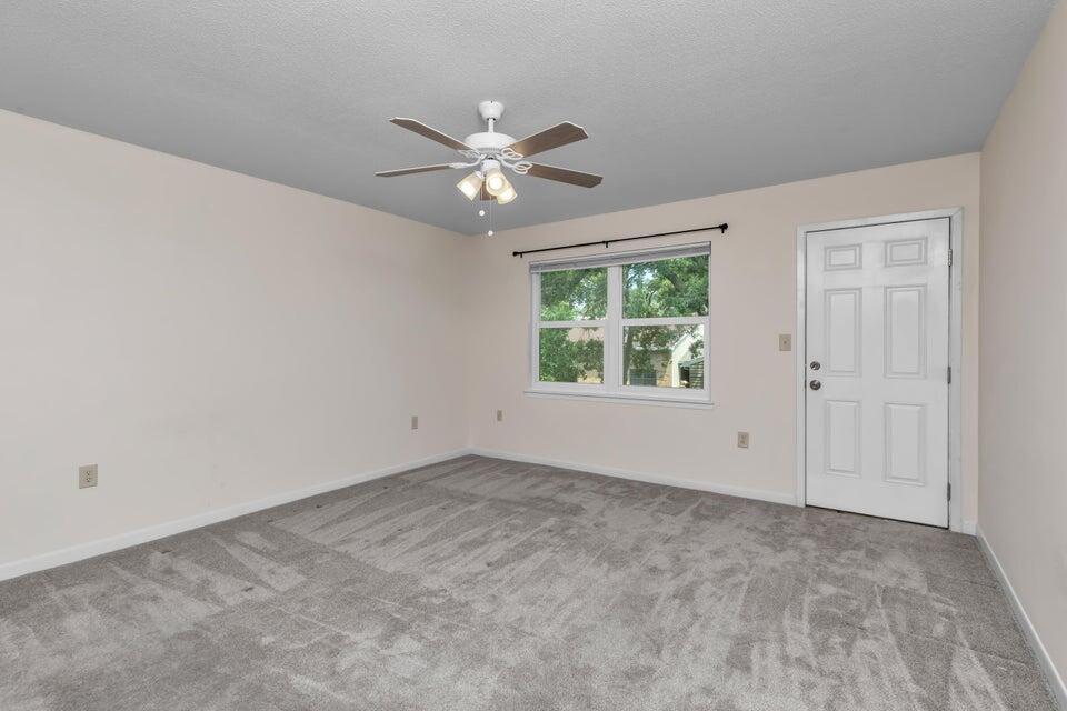 1037 4th Avenue Shalimar, FL 32579 - Photo 17 of 22 an empty room with a window and a fan