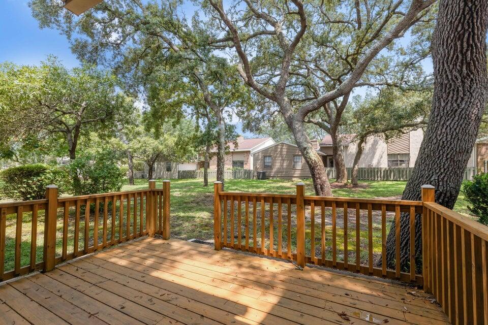 1037 4th Avenue Shalimar, FL 32579 - Photo 20 of 22 a view of a deck with wooden floor and fence next to a yard