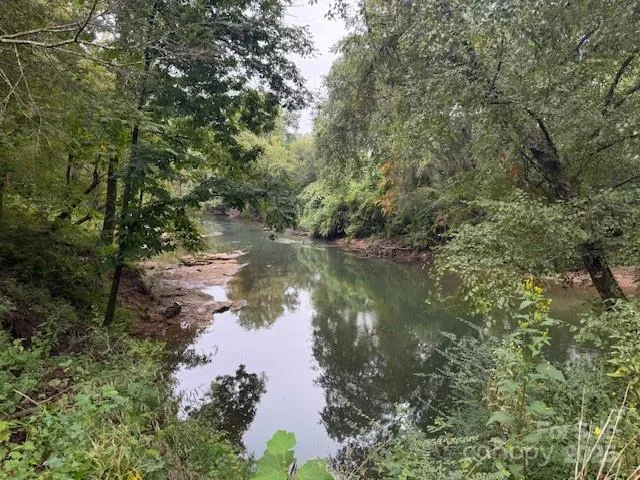 a view of outdoor space with swimming pool and trees