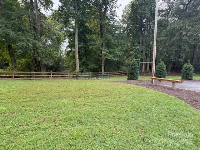 a backyard of a house with lots of green space and fountain