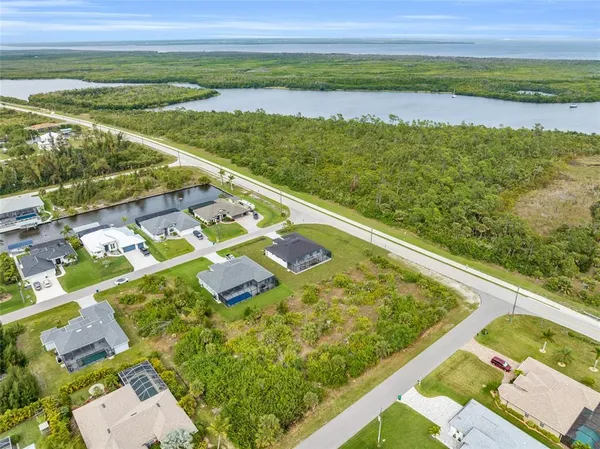 an aerial view of residential houses with outdoor space and swimming pool
