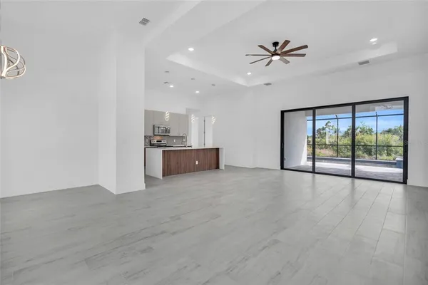 a large kitchen with a large window and stainless steel appliances