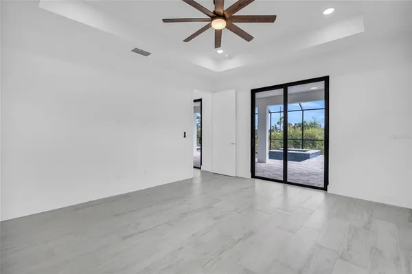 wooden floor in an empty room with a ceiling fan