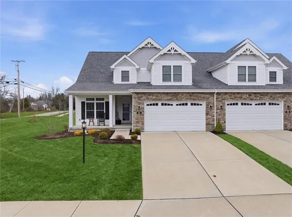 a front view of a house with a yard table and chairs