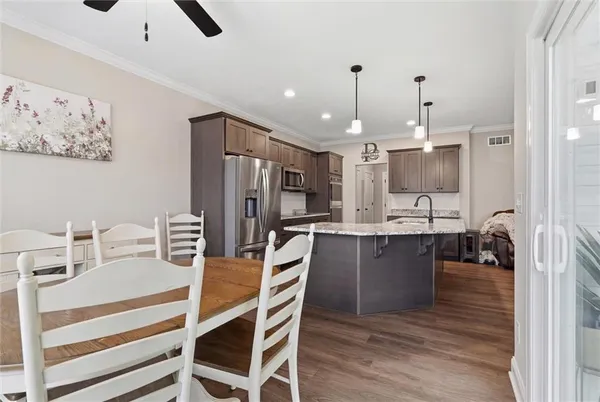 a kitchen with refrigerator cabinets and wooden floor