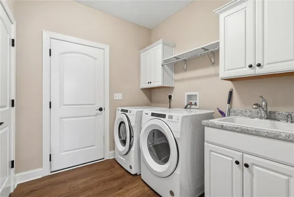 a utility room with sink dryer and washer