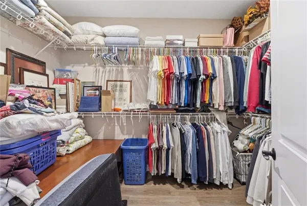 a view of walk in closet with clothes