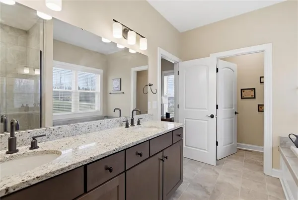 a bathroom with a granite countertop sink mirror and double